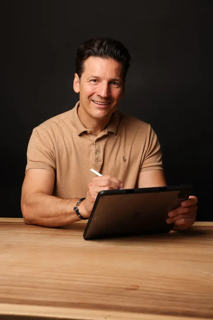 Jörg Vogelgesang mit Tablet am Schreibtisch